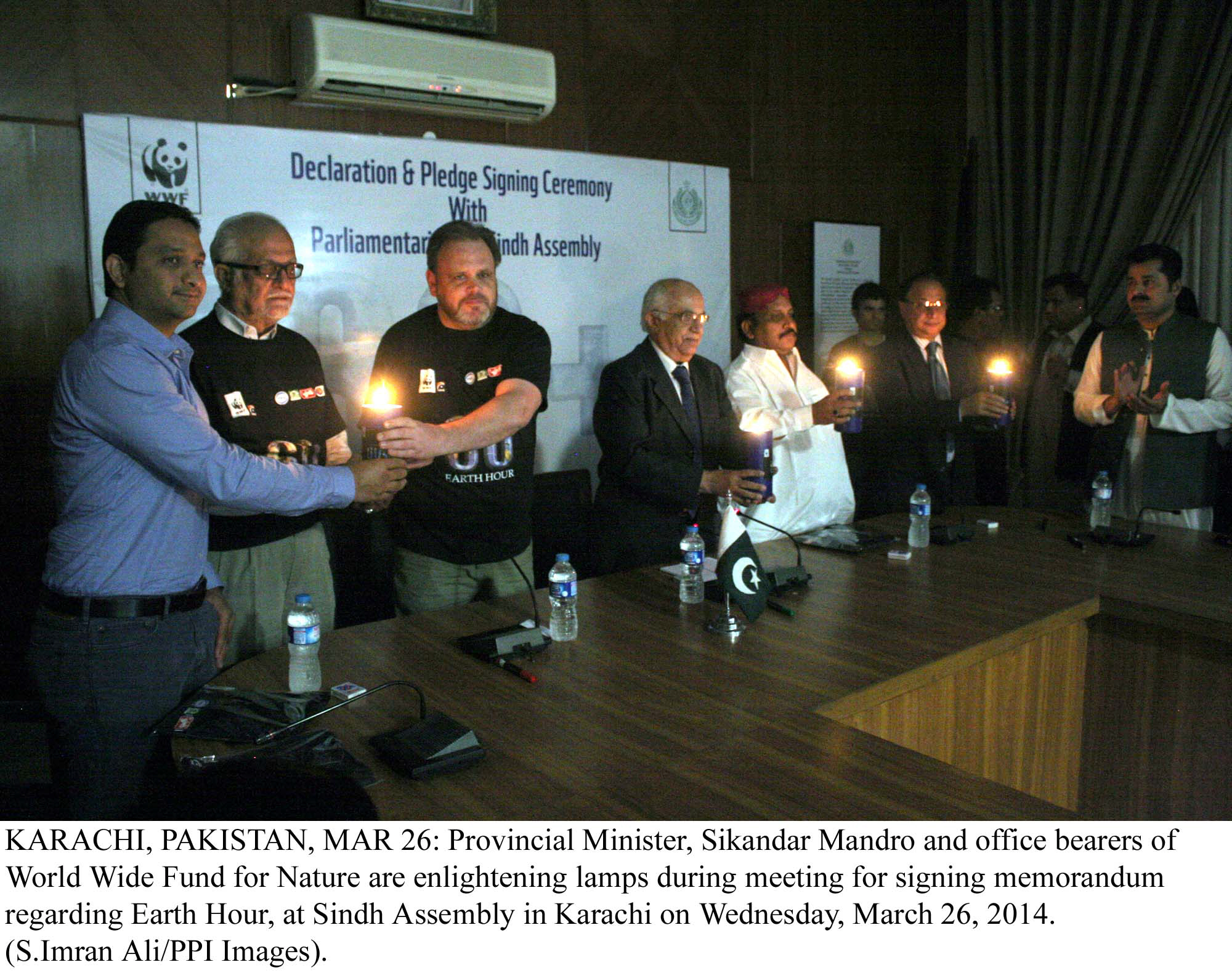 provincial minister sikandar mandhro along with officials of wwf light lamps after signing a memorandum for earth hour on wednesday photo ppi