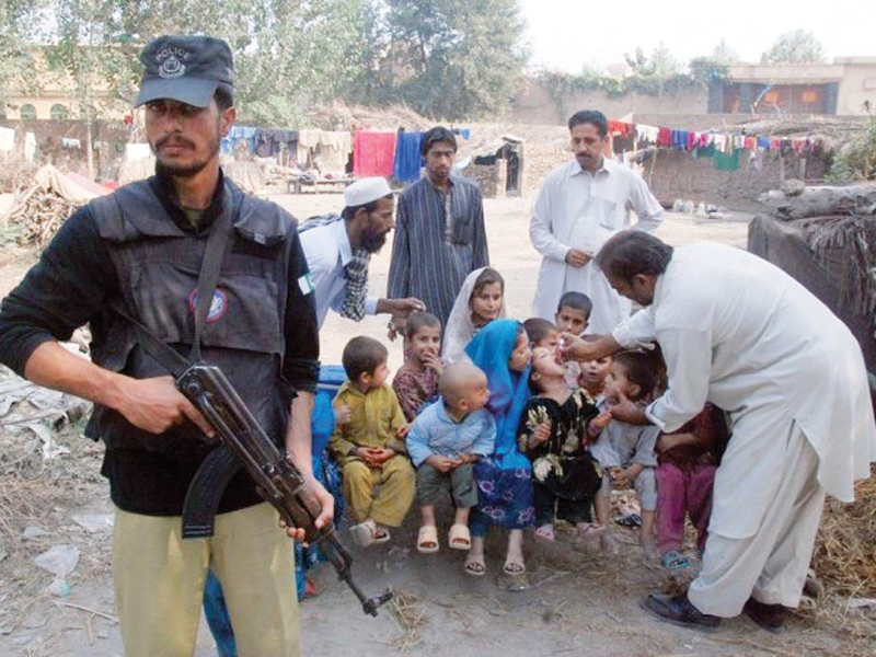 file photo of a police officer guarding a anti polio campaigner