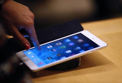 a woman looks at an apple ipad at one of the company 039 s stores in paris photo afp file