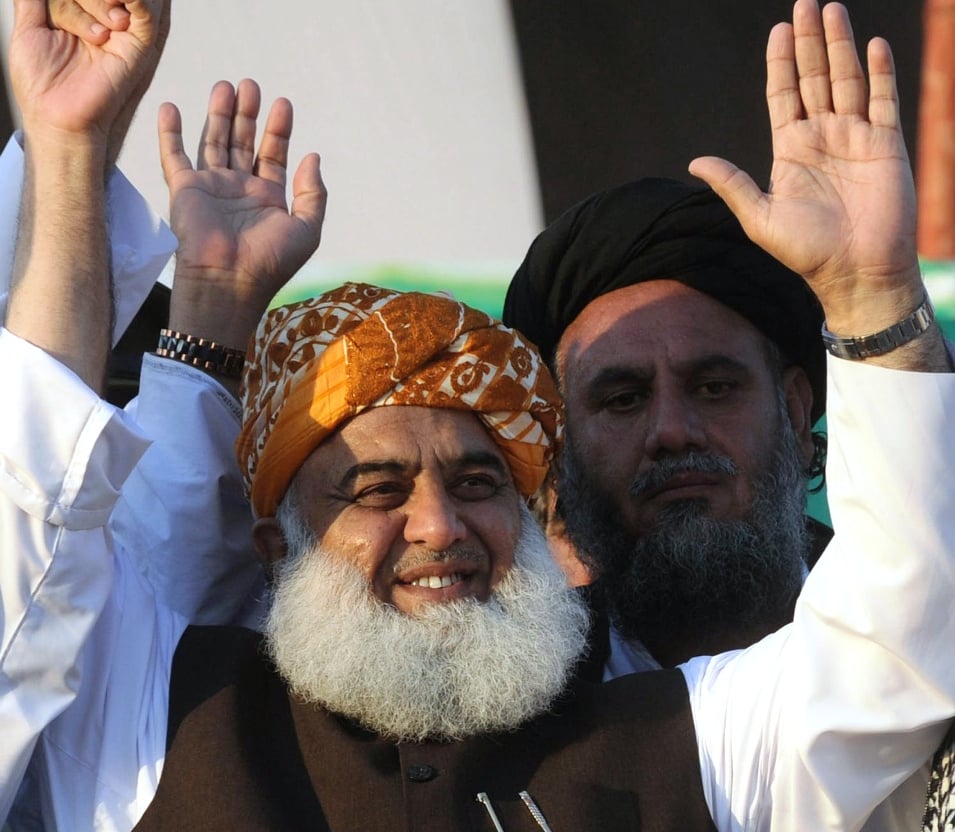 jui f head fazlur rehman gestures as he arrives to attend an election meeting in lahore on march 31 2013 photo afp