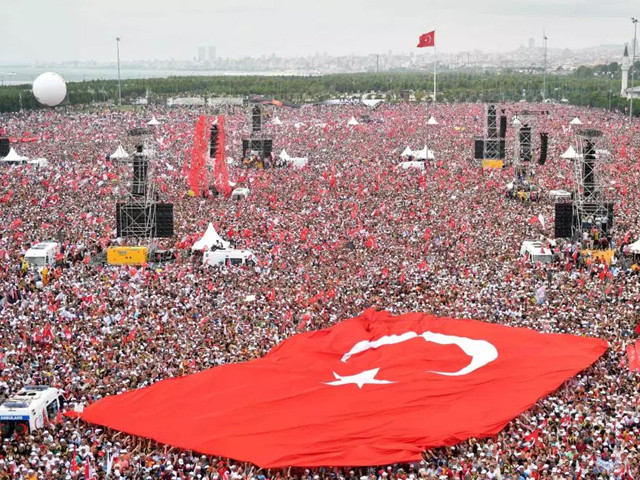 supporters hold a giant turkish flag during an election rally in ankara photo afp