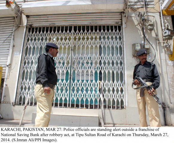 police officials stand guard outside the national savings bank that was robbed on thursday photo ppi police officials stand guard outside the national savings bank that was robbed on thursday photo ppi