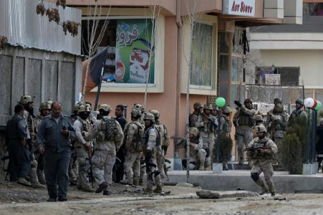afghan soldiers at the scene of attack on a guesthouse by taliban gunmen in kabul photo afp