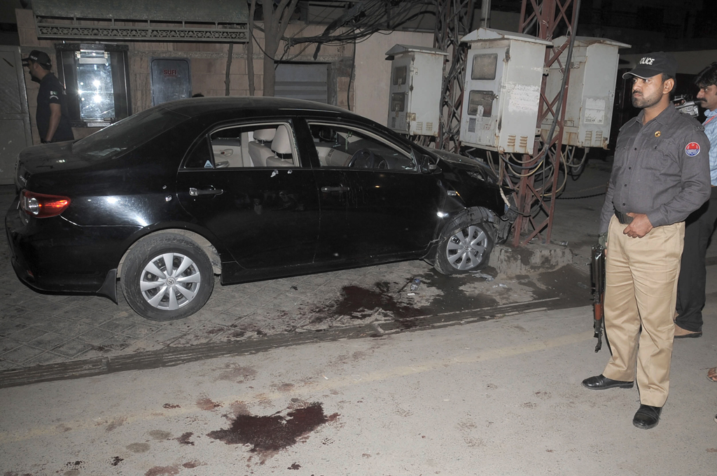 police official standing near raza rumi 039 s vehicle after he was attacked on friday evening photo tariq hasan express