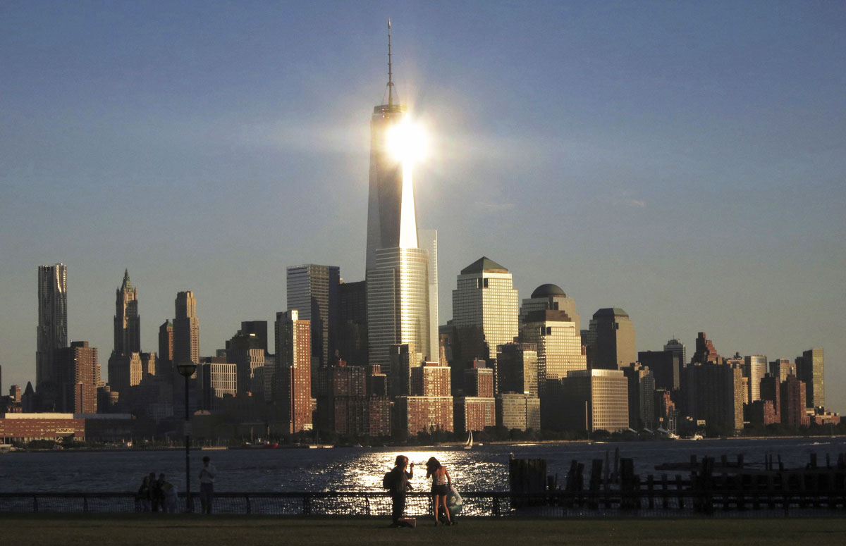 sun reflects off new york 039 s one world trade center as people stand in a park in hoboken new jersey in this file photo taken september 29 2013 photo reuters