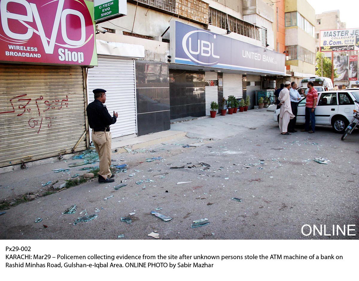 officials gather near the bank where robbers tried unsuccessfully to burgle its atm photo online