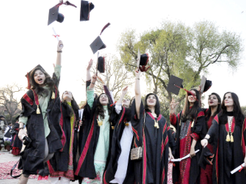 jubilant fresh graduates throw their caps in the air at the kinnaird college convocation on saturday photo abid nawaz express