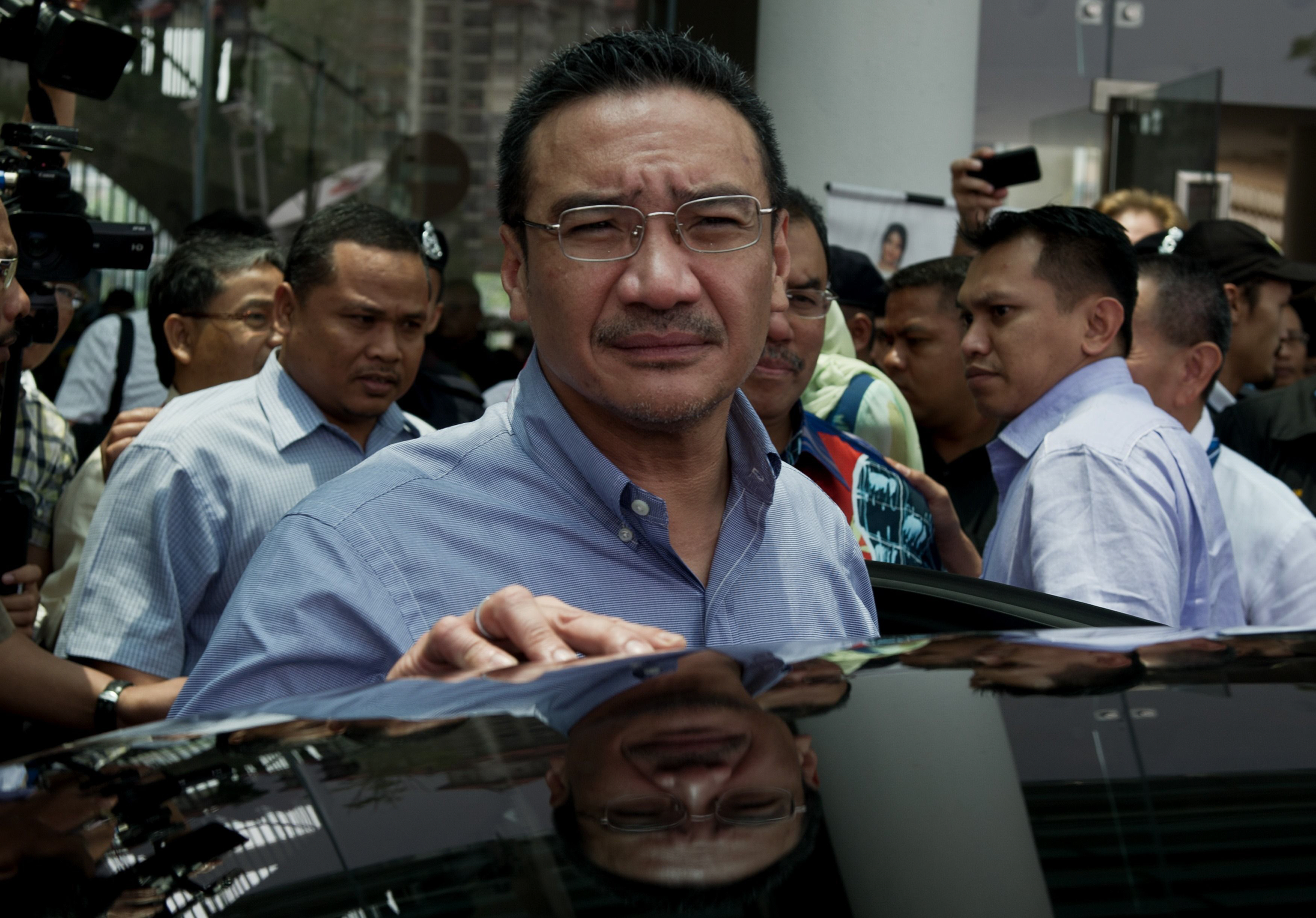 taken on march 29 this picture shows malaysia 039 s transport minister hishammuddin hussein c leaving after visiting relatives of passengers of the missing malaysia airlines flight mh370 at a hotel in putrajaya photo afp