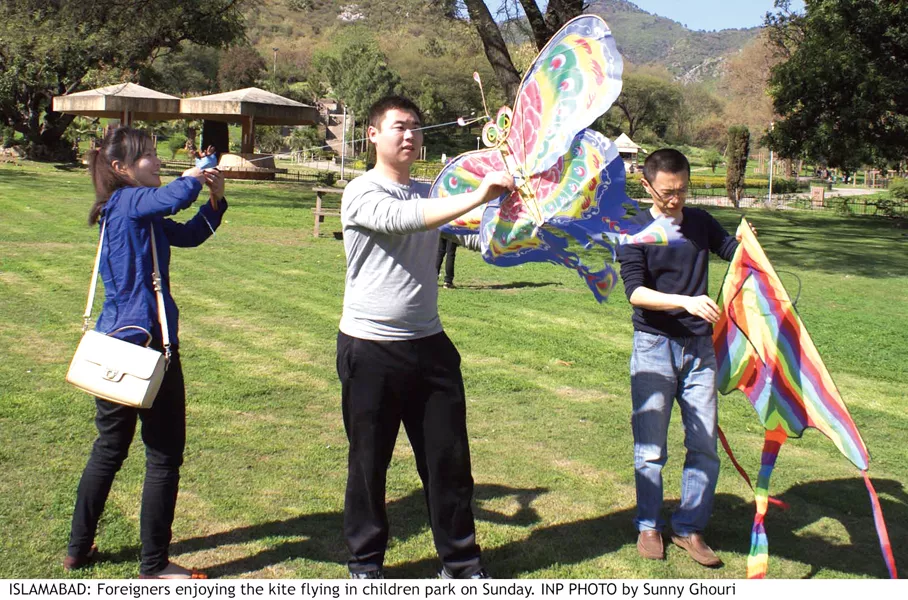 a family is enjoying the event while a group of foreigner try to fly kites photos inp a family is enjoying the event while a group of foreigner try to fly kites photos inp