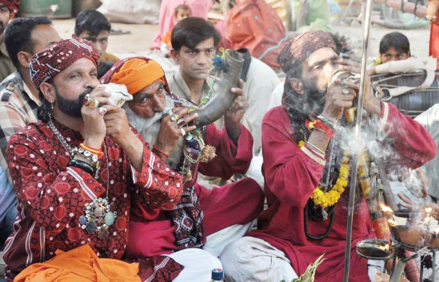 devotees blow horns at the urs of hazrat madhu lal hussain during festivities devotees blow horns at the urs of hazrat madhu lal hussain during festivities