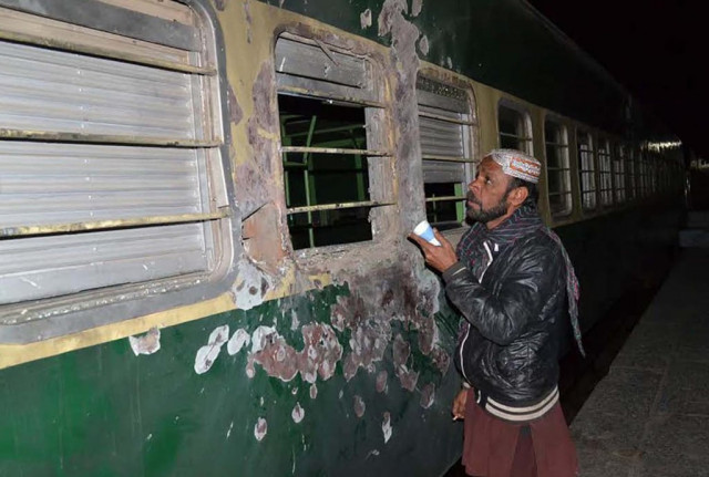 a man looking at the damaged akbar bugti express photo naseem james express a man looking at the damaged akbar bugti express photo naseem james express