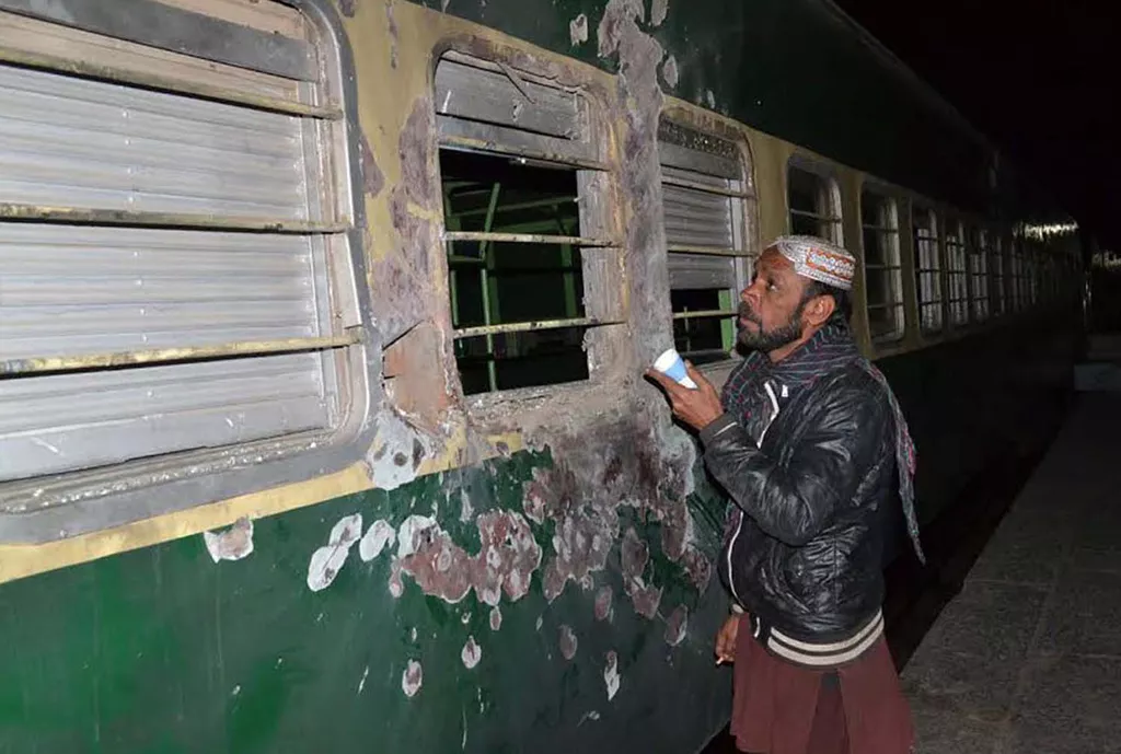 a man looking at the damaged akbar bugti express photo naseem james express a man looking at the damaged akbar bugti express photo naseem james express
