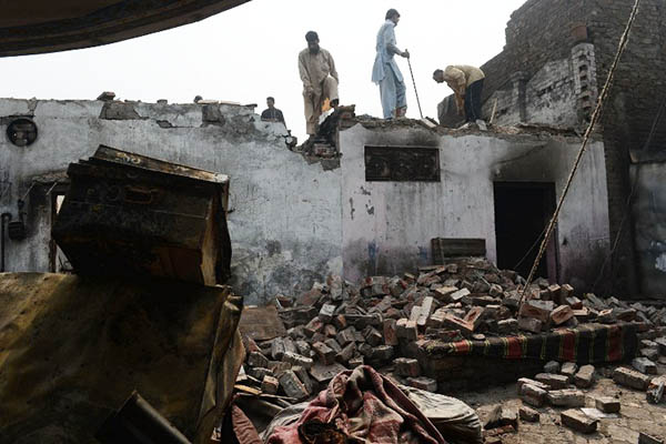 the remains of a house burnt to the ground by a mob in lahore march 2013 photo afp file