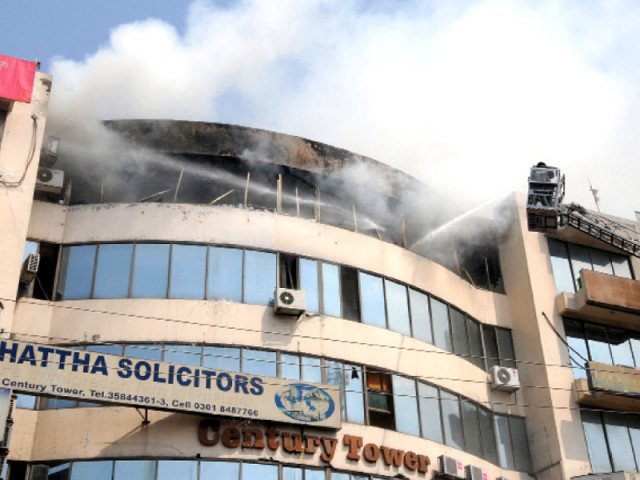 fire fighters putting out fire that erupted on the fourth floor of century tower on tuesday photo shafiq malik express fire fighters putting out fire that erupted on the fourth floor of century tower on tuesday photo shafiq malik express