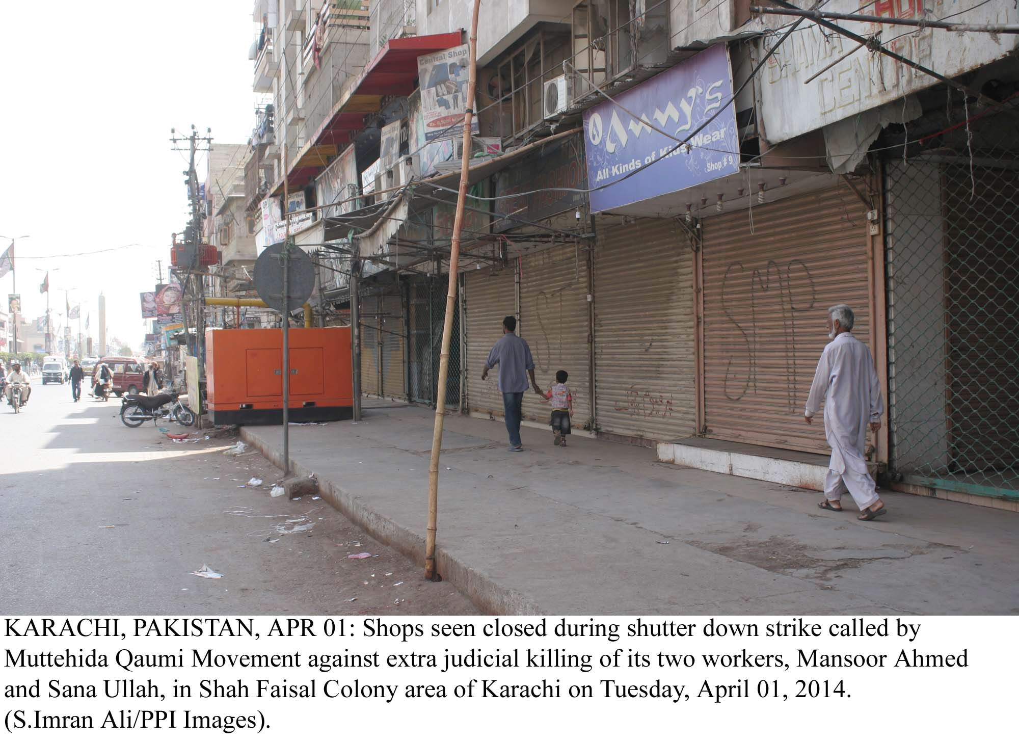 residents walk past closed shops in shah faisal colony area of karachi after the mqm called for a strike photo ppi