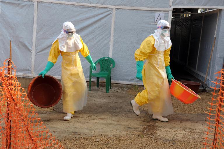 doctors in protective gear work on march 31 2014 inside the medical humanitarian group medecins sans frontieres doctors without borders isolation ward in the southern guinean town of gueckedou photo afp