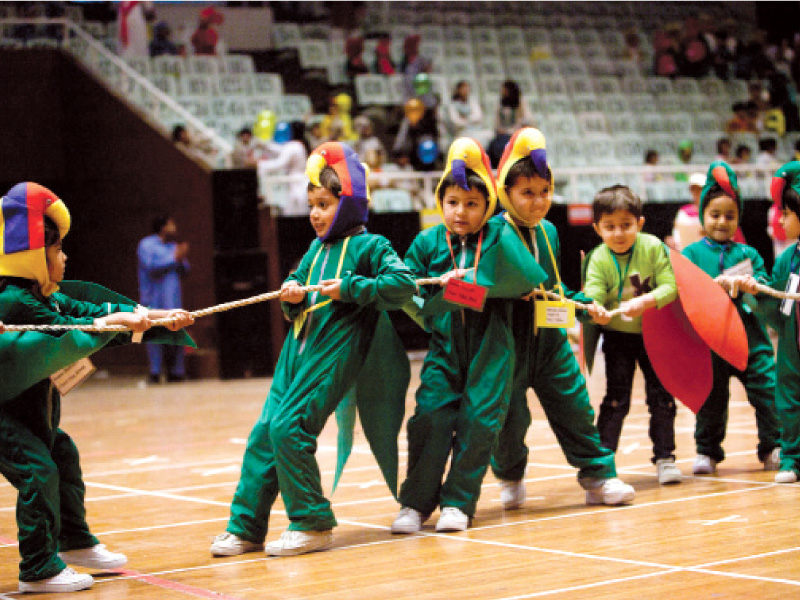 two teams of kindergarten children pull the rope with all their best strength to win the game photo express