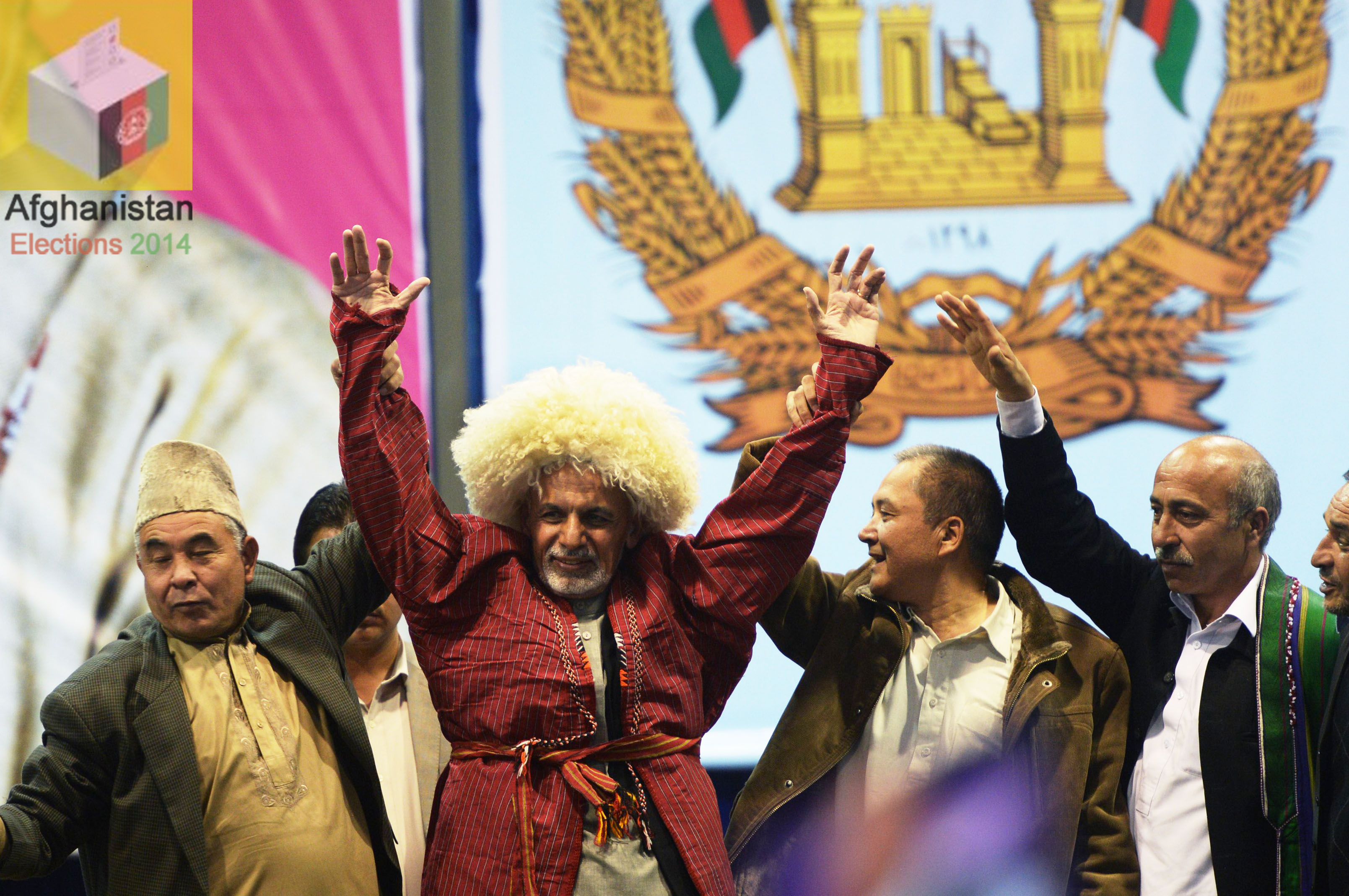 afghan presidential candidate ashraf ghani ahmadzai c wears a typical northern hat offered to him as a gift during his closing campaign rally at a local hall for a rally on the last day of the presidential campaign on april 2 2014 photo afp