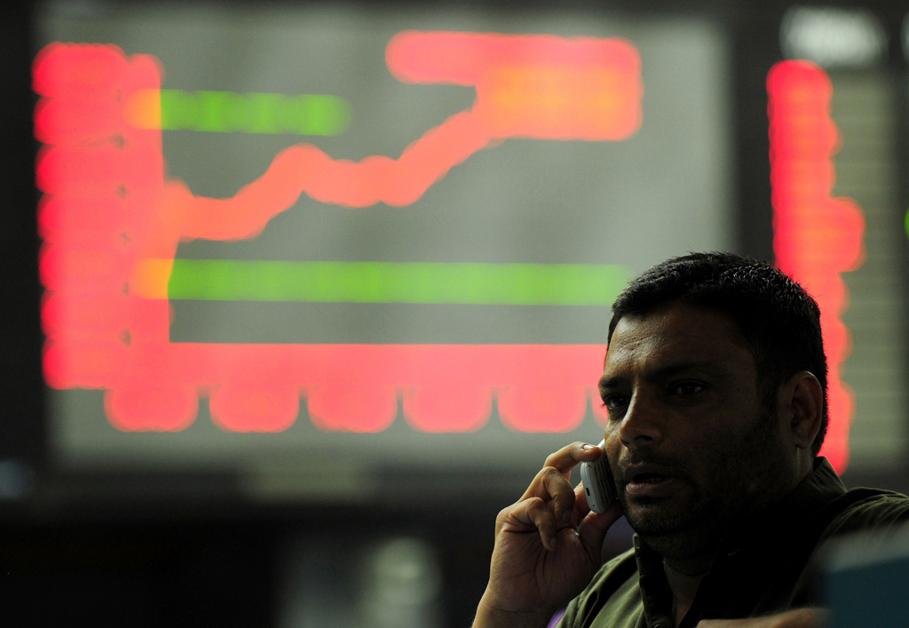 a pakistani stockbroker talks on the phone during a trading session at the karachi stock exchange kse in karachi on april 3 2014 photo afp