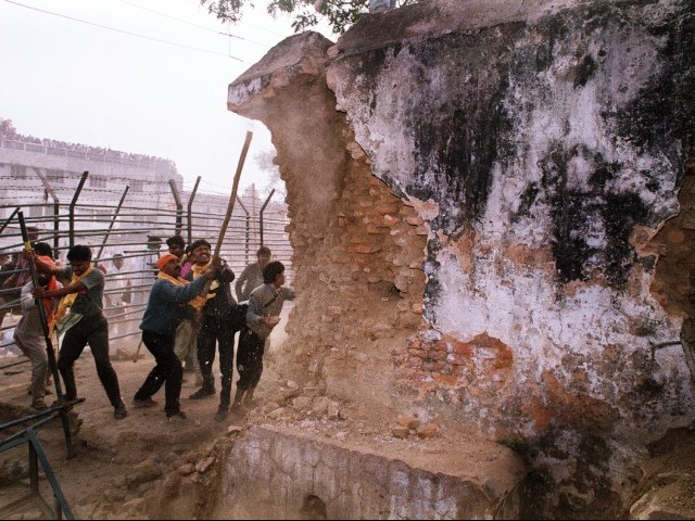 in this december 6 1992 photograph rioters attack the wall of the 16th century babri masjid mosque with iron rods at a disputed holy site in the city of ayodhya photo afp file