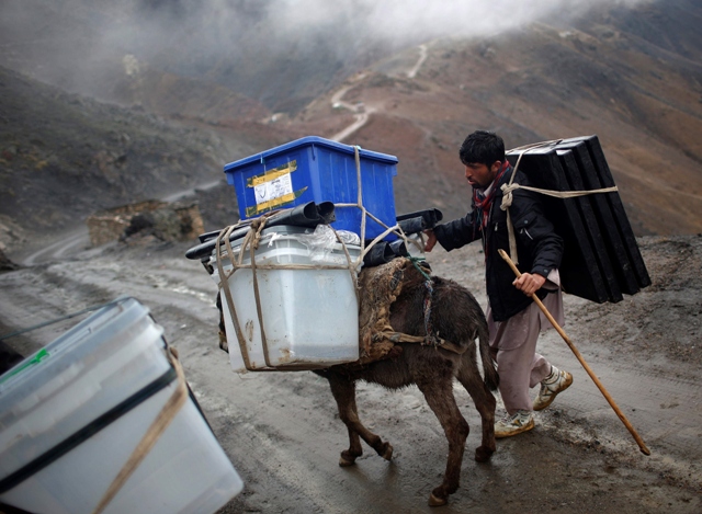 an afghan man tries to control his donkey loaded with ballot boxes to be transported to polling stations which are not accessible by road in shutul panjshir province april 4 2014 photo reuters