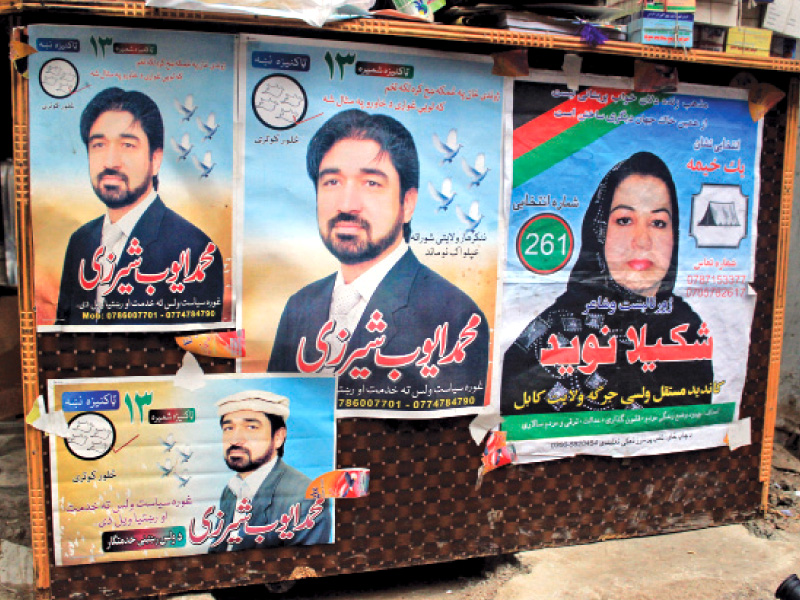 posters of afghan presidential candidates cover shop fronts in mohallah jangi photo muhammad iqbal express