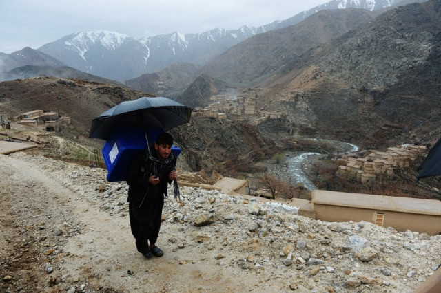 an afghan villager carries election materials over his back as he hikes to his village along a country road high in the mountains of shutul district in northern afghanistan photo afp an afghan villager carries election materials over his back as he hikes to his village along a country road high in the mountains of shutul district in northern afghanistan photo afp
