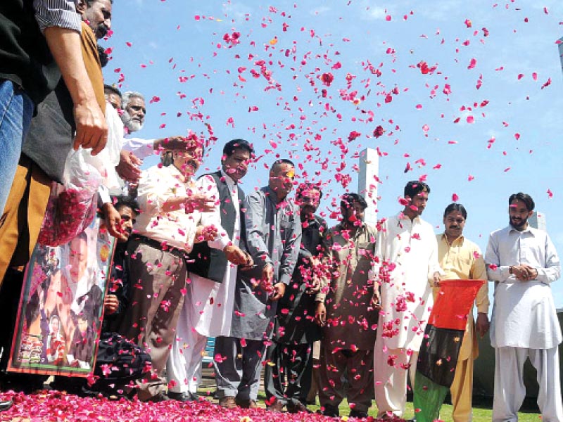 ppp rawalpindi activists placing petals at the site at jinnah park where bhutto was hanged photo express