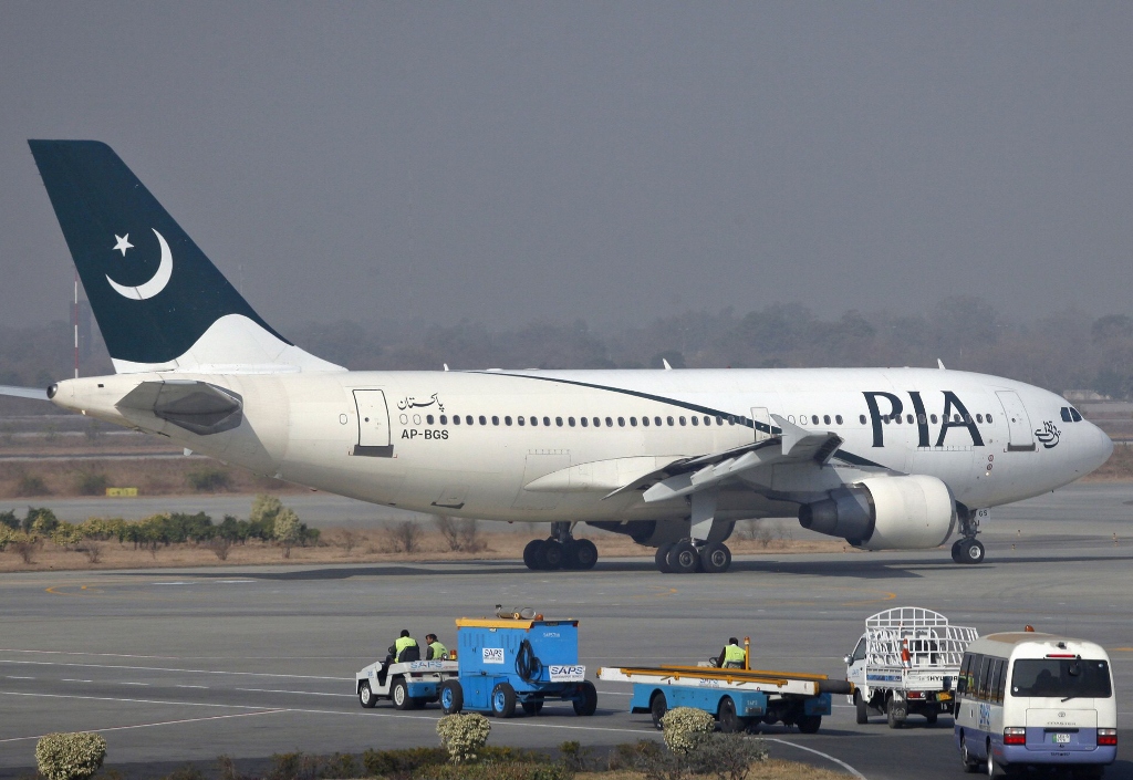 a pakistan international airlines pia plane prepares to take off at alama iqbal international airport in lahore photo reuters