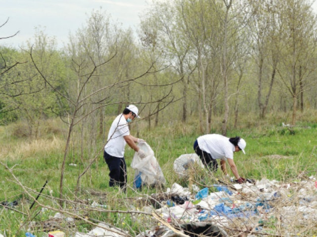 volunteers carry plastic bags as they take part in the clean up drive some 50 people took part photo afp volunteers carry plastic bags as they take part in the clean up drive some 50 people took part photo afp