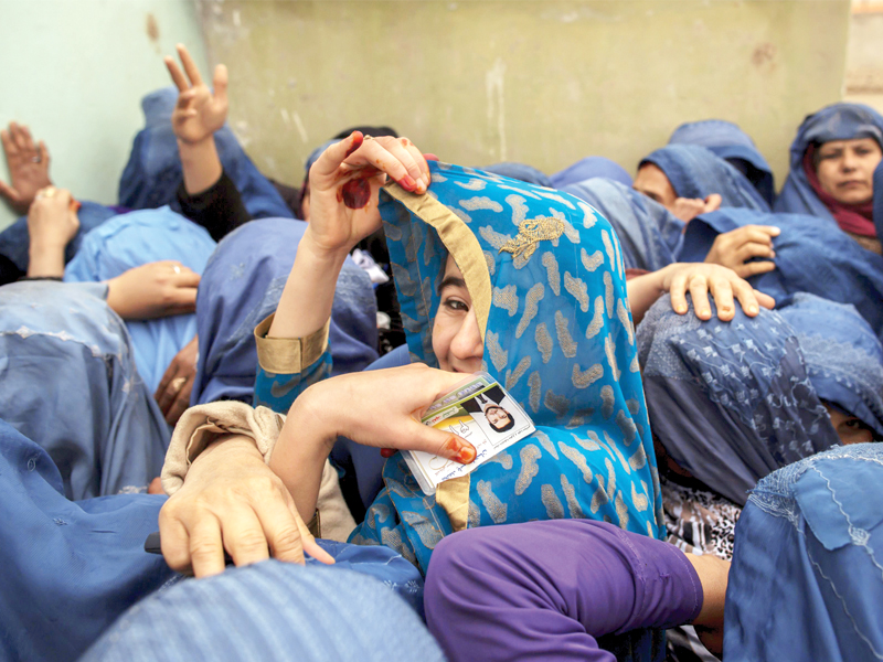 women wait to cast their ballots at a polling station in mazar i sharif photo reuters