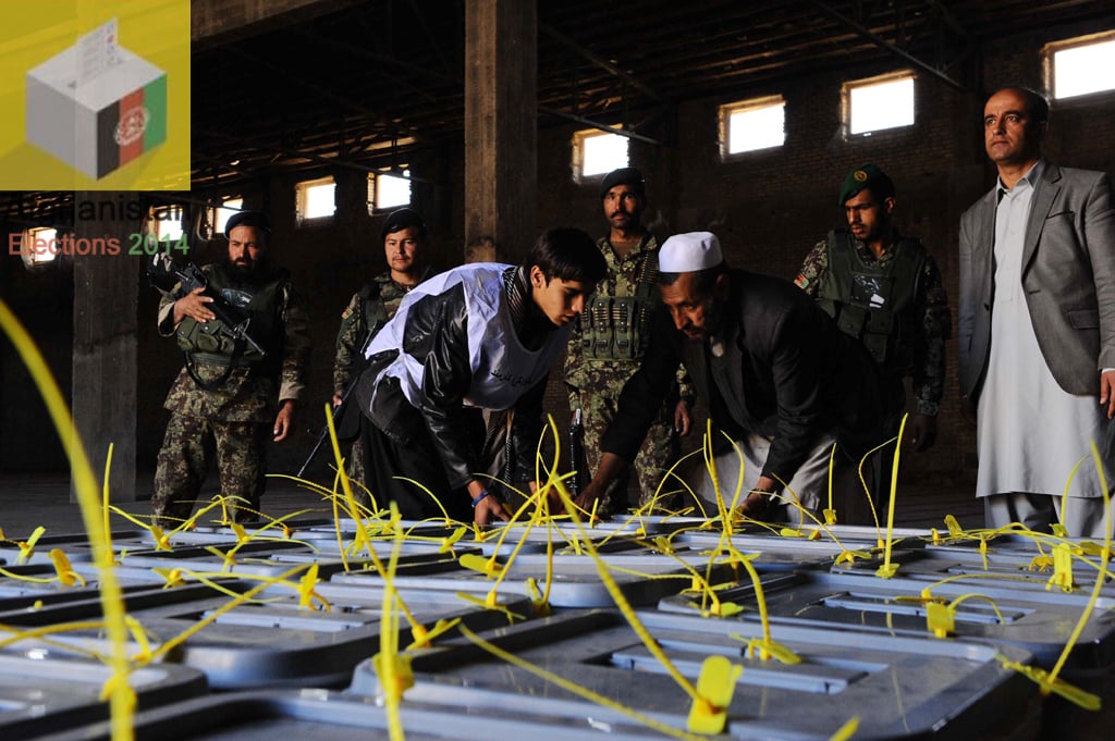 afghan workers arrange ballot boxes at an independent election commission office in herat on april 6 2014 photo afp