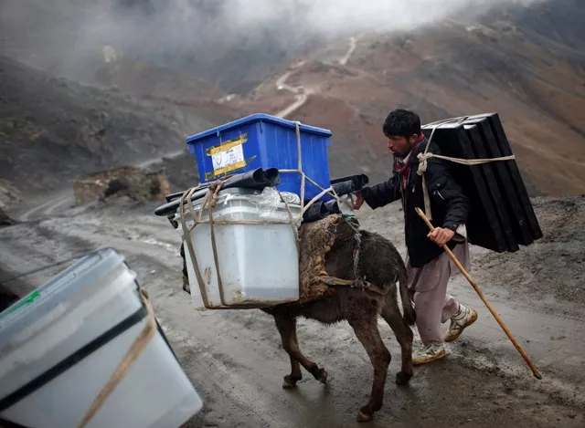 an afghan man tries to control his donkey loaded with ballot boxes to be transported to polling stations which are not accessible by road in shutul panjshir province april 4 2014 photo reuters an afghan man tries to control his donkey loaded with ballot boxes to be transported to polling stations which are not accessible by road in shutul panjshir province april 4 2014 photo reuters