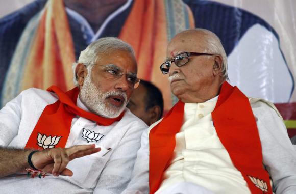 bjp leader lal krishna advani r listens to bjp prime ministerial candidate narendra modi during a workers 039 party meeting ahead of the general election at gandhinagar in gujarat on april 5 2014 photo reuters