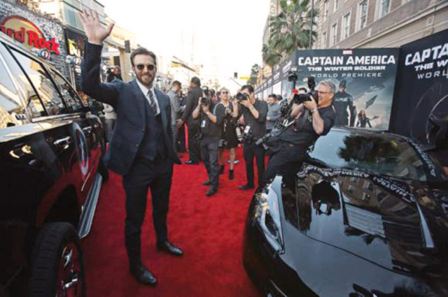 cast member chris evans waves at the premiere of captain america the winter soldier at el capitan theatre in hollywood photo file cast member chris evans waves at the premiere of captain america the winter soldier at el capitan theatre in hollywood photo file