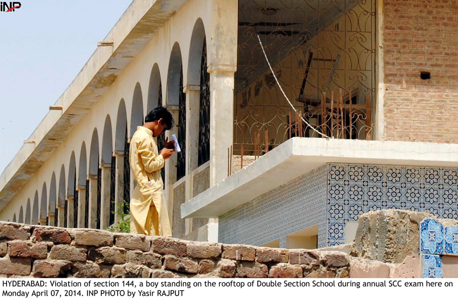 a boy violates section 144 which has been imposed for the matric examinations by standing on the rooftop of a school in hyderabad on monday photo inp