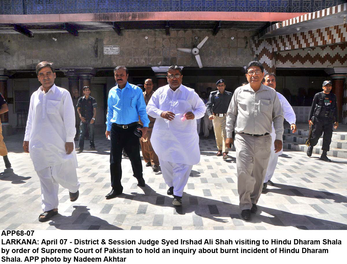 district and sessions judge syed irshad ali shah visiting the vandalised hindu dharam shala and temple in larkana on monday photo app