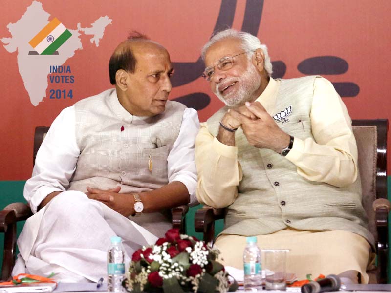 narendra modi r speaks with his party s president rajnath singh before releasing their election manifesto photo reuters