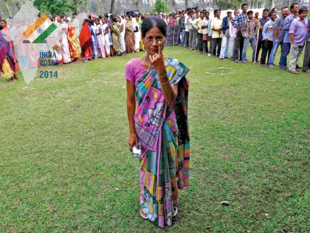 a woman shows her ink marked finger after casting her vote in assam photo reuters
