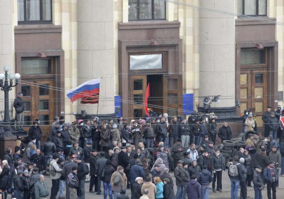 pro russian protesters gather outside the regional administrative building in the eastern city of kharkiv april 7 2014 photo reuters