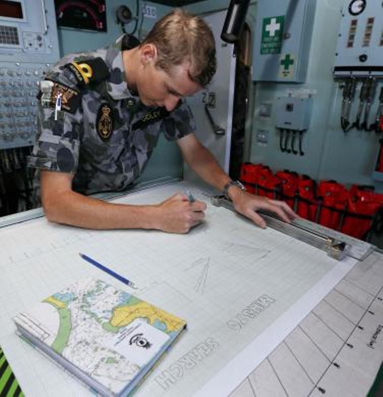 maritime warfare officer sub lieutenant scott gidley plots a course aboard the australian navy ship hmas perth for the distance to run with fuel to reach the search zone for the missing malaysian airlines flight mh370 in the southern indian ocean in this picture released by the australian defence force april 8 2014 photo reuters