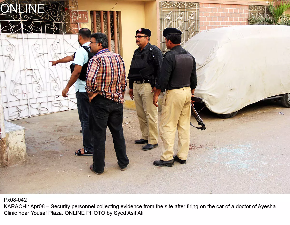 officials gather evidence from where the car of a doctor was targeted in karachi on tuesday photo online officials gather evidence from where the car of a doctor was targeted in karachi on tuesday photo online