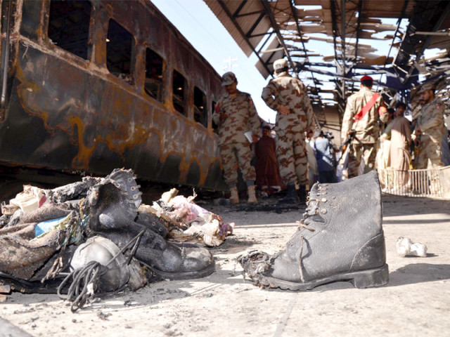 security officials gather beside the wreckage of the train after an attack at the sibi railway station photo afp security officials gather beside the wreckage of the train after an attack at the sibi railway station photo afp