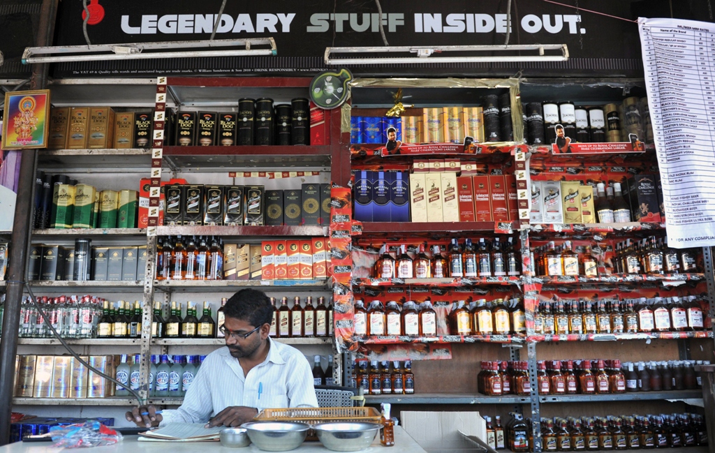 an indian employee writes down stock at an alcohol store in hyderabad photo afp