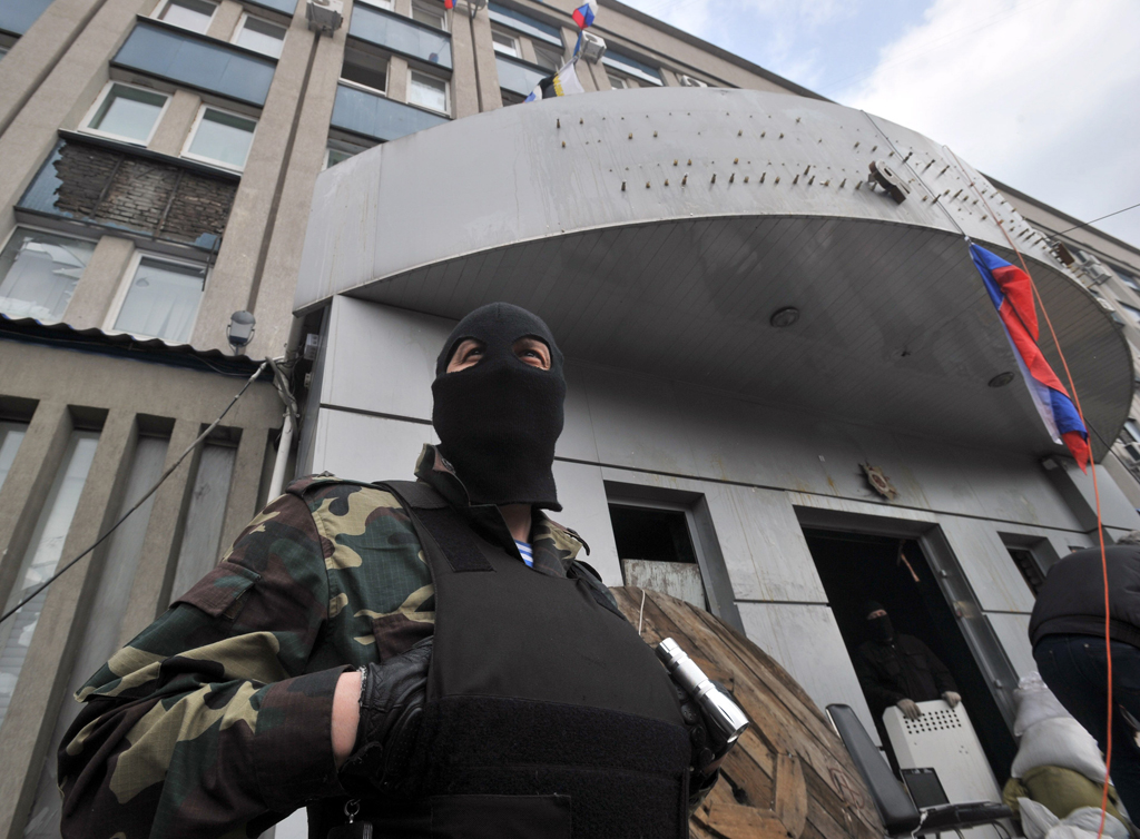 pro russian activists the entrance of the regional security service building in the eastern ukrainian city of lugansk on april 9 2014 photo afp