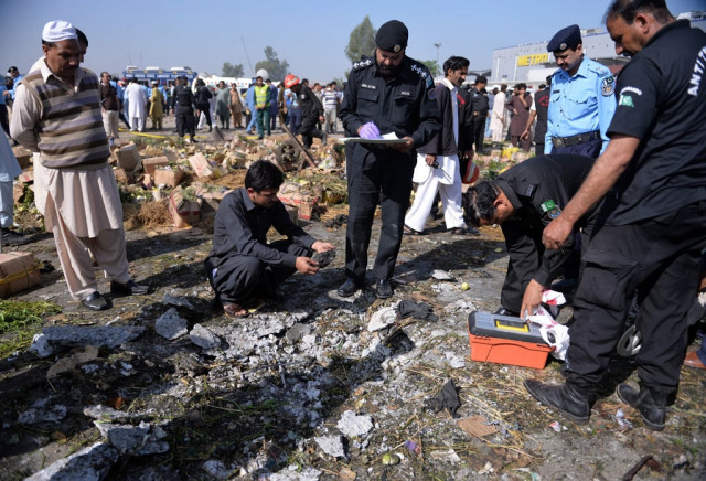 pakistani security officials inspect the site of a bomb explosion in a fruit and vegetable market in islamabad on april 9 2014 photo afp pakistani security officials inspect the site of a bomb explosion in a fruit and vegetable market in islamabad on april 9 2014 photo afp