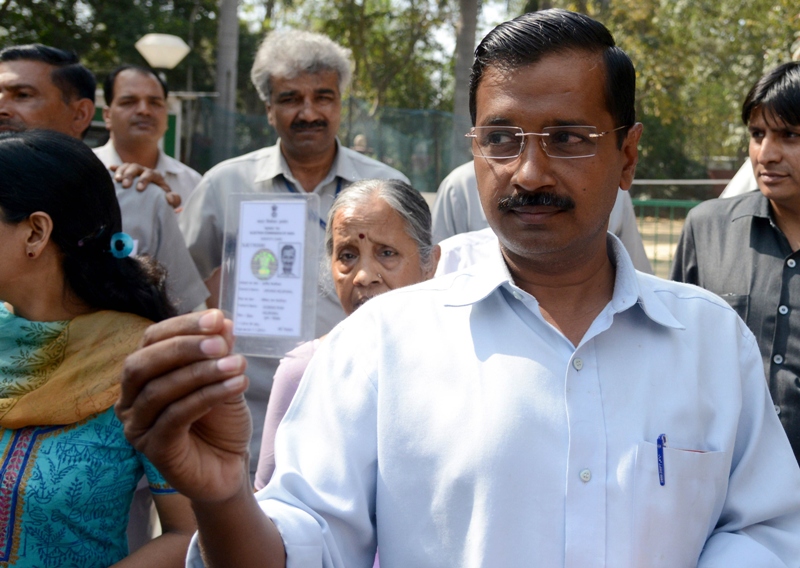 leader of india 039 s aam admi party aap arvind kejriwal r shows his voters card at a polling station in new delhi photo file