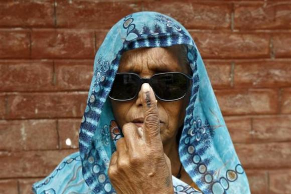 a woman shows her ink marked finger after casting her vote at makum village in tinsukia district of assam april 7 2014 photo reuters