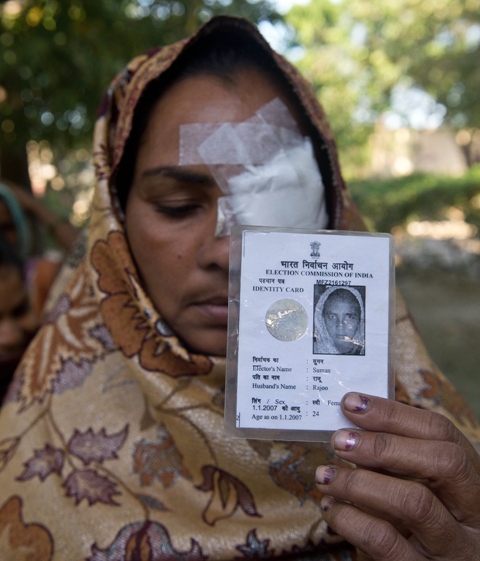 an indian resident holds her election card as she queues with other to cast their votes at a polling centre in the village of jaula in muzaffarnagar district on thursday april 10 photo file