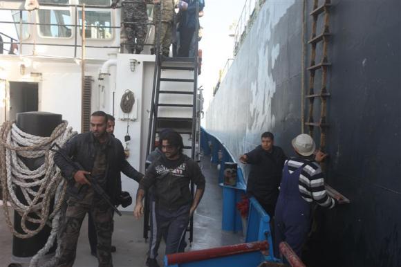 crew members of the morning glory are escorted by libyan naval personnel to a port in tripoli march 23 2014 photo reuters